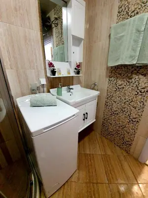a bathroom with a white sink and a mirror at Old Sailor Apartment in Obzor