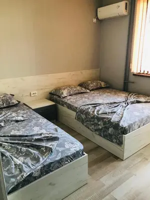 a room with two beds and a window at Семейна къща “Вълчеви” in Kiten