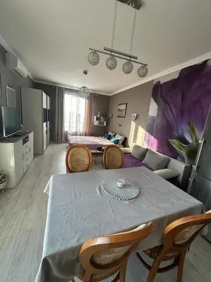 a room with a table and chairs and a living room at Golden Sun in Pomorie