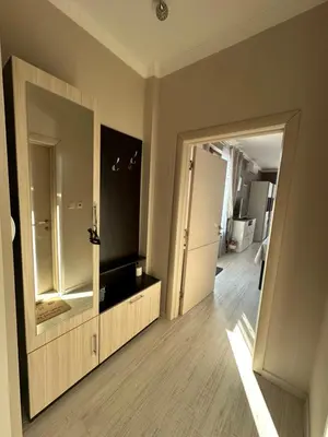 a bathroom with a large mirror and a wooden floor at Golden Sun in Pomorie
