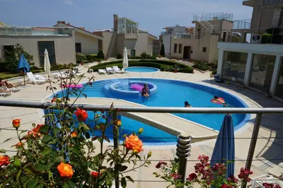 a pool with two people playing in it at Sun Village Family Houses in Byala