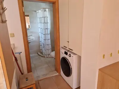 a washing machine in a bathroom with a shower at Sun Village Family Houses in Byala
