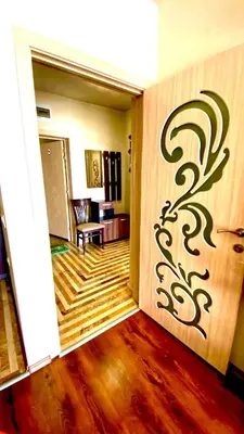 a living room with a door with a painting on the wall at DIAMOND APARTMENT №1 - RELAX HOLIDAY VIEWS SEA AND POOL in Burgas City