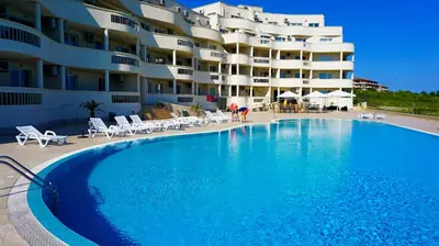 a large swimming pool in front of a building at Апартаменти Сънбрийз - Sunbreeze Apartments in Byala