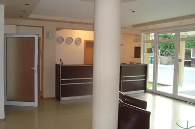 a column in a room with chairs and a pole at Hotel Astra in Ravda