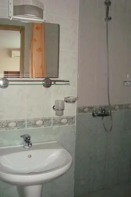 a bathroom with a sink and a shower at Hotel Astra in Ravda