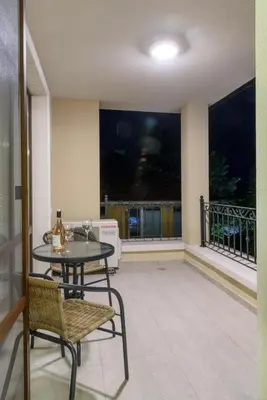 a balcony with a table and chairs and a window at Gradina in Chernomorets