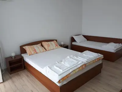 a small bedroom with a bed and a couch at Gradina in Chernomorets