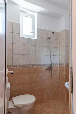 a bathroom with a shower with a toilet and a sink at Gradina in Chernomorets