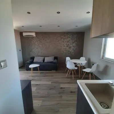 a living room with a couch and a table and chairs at Gradina in Chernomorets