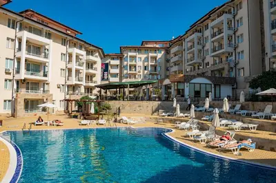 a hotel with a swimming pool in front of buildings at Sunny Beach Hills - Menada Apartments in Sunny Beach