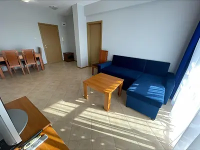 a living room with a blue couch and a table at Sunny Beach Hills - Menada Apartments in Sunny Beach