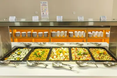 a buffet line with many different types of food at Kuban Resort & Aquapark - All Inclusive in Sunny Beach
