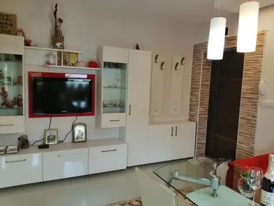 a living room with white cabinets and a television at Apartament Peyo Yavorov in Burgas City