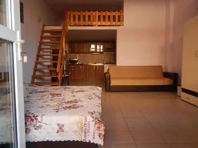a living room with a couch and a staircase at Dunav Str. in Ravda