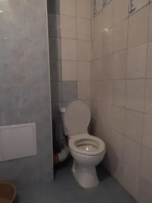 a bathroom with a toilet in a tiled room at Dunav Str. in Ravda