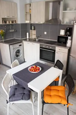 a kitchen with a table with a bowl of fruit on it at Vera by RV Apartments in Varna City
