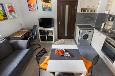 a small living room with a table and a kitchen at Vera by RV Apartments in Varna City