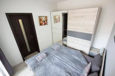 a bedroom with a bed with two towels on it at Vera by RV Apartments in Varna City