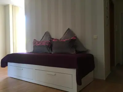a bed with four pillows on it in a room at Apartment in Nessebar Fort Club in Sunny Beach