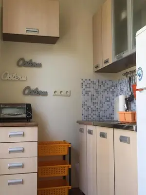 a kitchen with white cabinets and a counter top at Apartment in Nessebar Fort Club in Sunny Beach