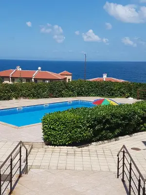 a swimming pool with the ocean in the background at Apartment Zora in Sozopol