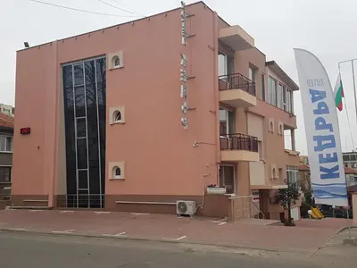 a building with a sign on the side of it at Family Hotel Kedara in Burgas City