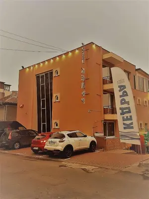 a building with a car parked in front of it at Family Hotel Kedara in Burgas City