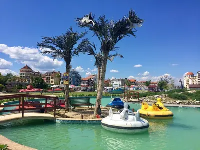 a water park with two boats in the water at Helga Apartment in Obzor