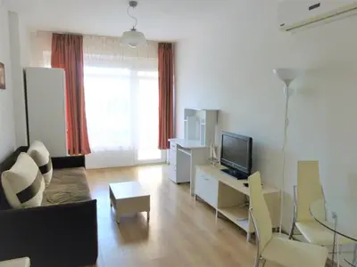 a living room with a couch and a television at Apartment Lozenets in Lozenets