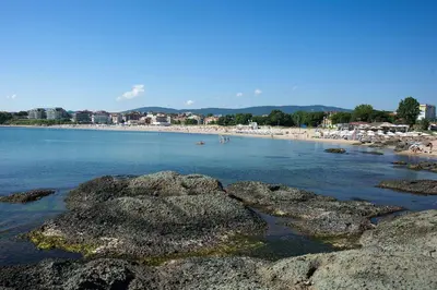a beach with rocks and people in the water at Apartment Lozenets in Lozenets