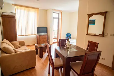 a living room with a table and a couch at Apartment Garden of Eden in Sveti Vlas