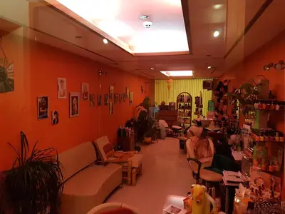 a room with orange walls and couches in a store at Apartment Garden of Eden in Sveti Vlas
