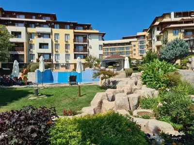 a garden with a swimming pool and some buildings at Apartment Garden of Eden in Sveti Vlas