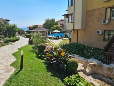a garden in front of a building with flowers at Apartment Garden of Eden in Sveti Vlas
