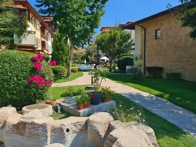 a garden with potted plants and a stone wall at Apartment Garden of Eden in Sveti Vlas
