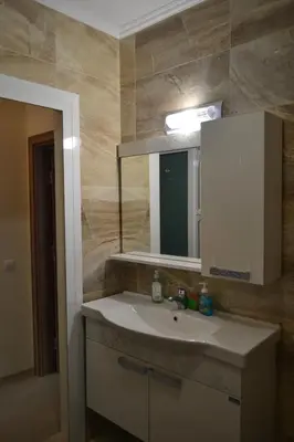 a bathroom with a sink and a mirror at Apartment Aquamarine in Burgas City
