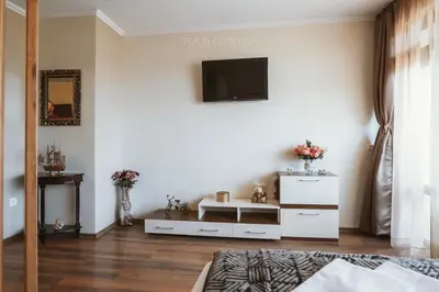 a living room with a television on a wall at Apartment 7 and Studio 2 Quietly and peaceful place to relax in Sozopol