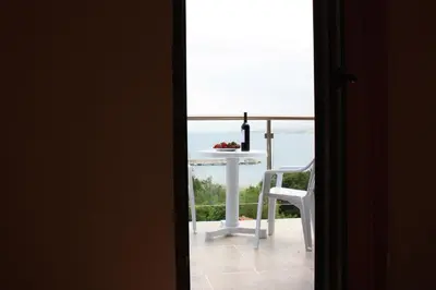 a view of a table and a chair on a balcony at Style Place in Kiten