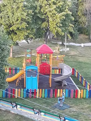 a playground with a slide and a play structure at Style Place in Kiten