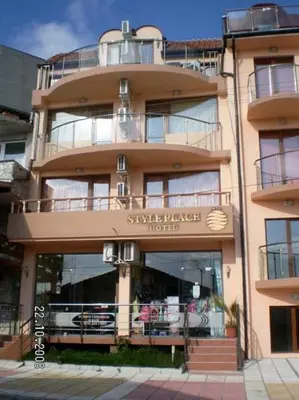 a large building with a sign for a hotel at Style Place in Kiten