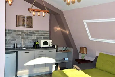 a living room with a couch and a kitchen at Boutique Villa Amalia in Chernomorets
