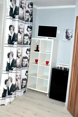 a living room with a backdrop of a collage of people at Boutique Villa Amalia in Chernomorets