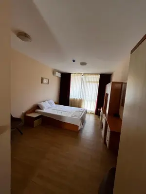 a hotel room with a bed and a television at Mario Beach Apartment Nessebar in Nesebar