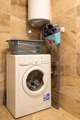 a washing machine with a light on top of it at Apartment EliMar in Burgas City
