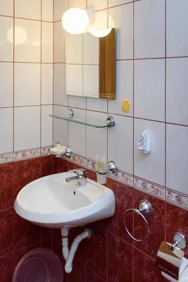 a bathroom with a white sink and a mirror at Guest House Ianis Paradise in Nesebar