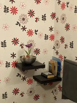a wall with flowers on it with a bowl on a shelf at Квартира у моря in Pomorie