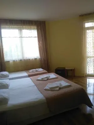 a bedroom with two beds with towels on them at Central Plaza Apartment in Sunny Beach