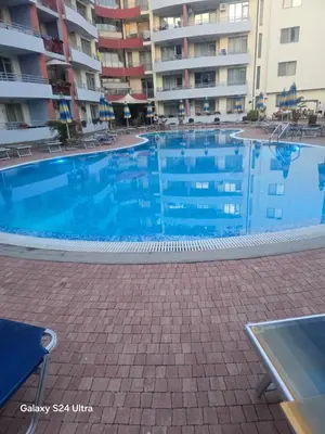 a large swimming pool in front of a building at Central Plaza Apartment in Sunny Beach
