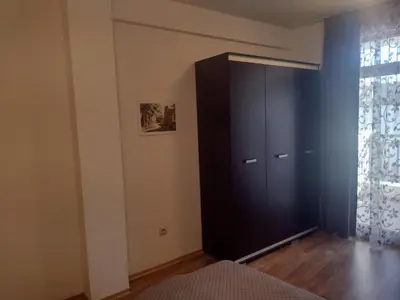 a black cabinet in a room with a window at Къща за гости Мускат 2 in Aheloy